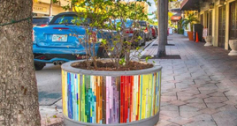 Image of a sidewalk planter covered in mosaic tiles